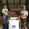 Team members at Cacao Fiji bagging cocoa beans ready for shipment